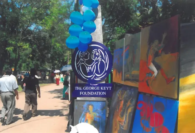 The Greek event features a cultural festival with an array of paintings and festive balloons adorning the scene.