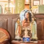 A woman sits in a chair, gazing into a mirror, reflecting a moment of contemplation and self-reflection.