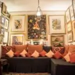 A stylish living room showcasing a plush couch and decorative pictures displayed on the walls.