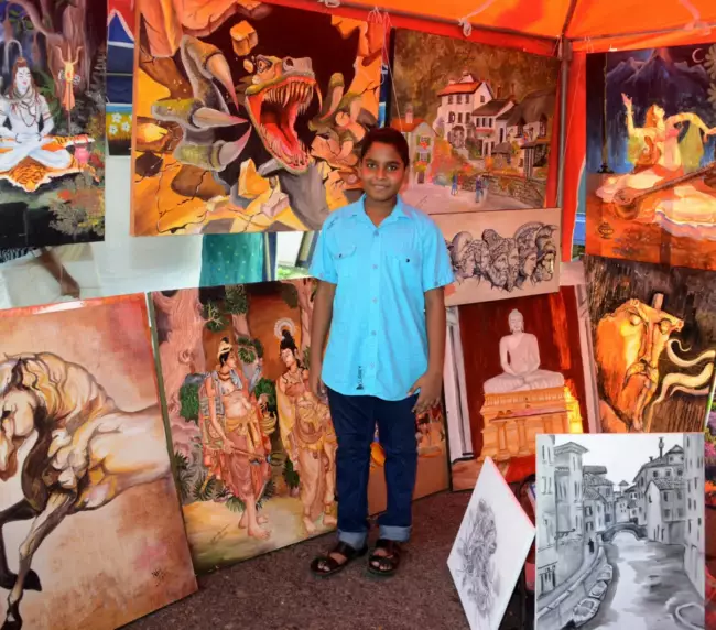 a small boy standing inside a art stall