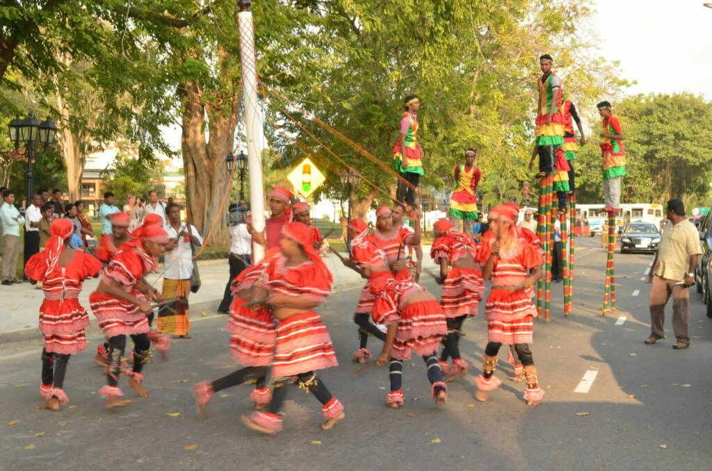 A lively group of people joyfully dancing together on a vibrant city street, showcasing community spirit and celebration.