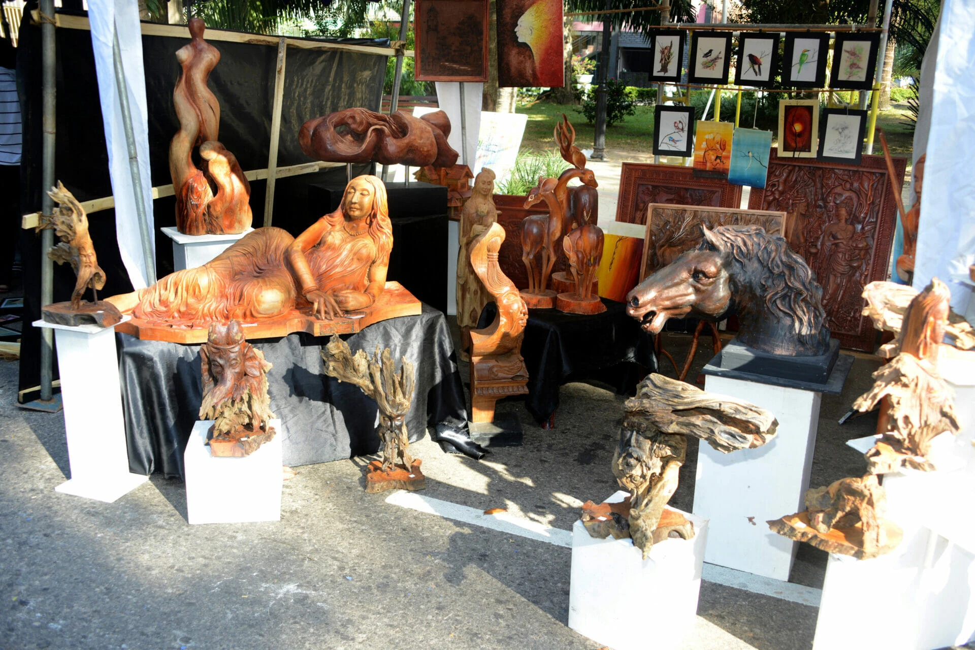 A group of unique sculptures arranged in a gallery, highlighting different forms and artistic expressions.