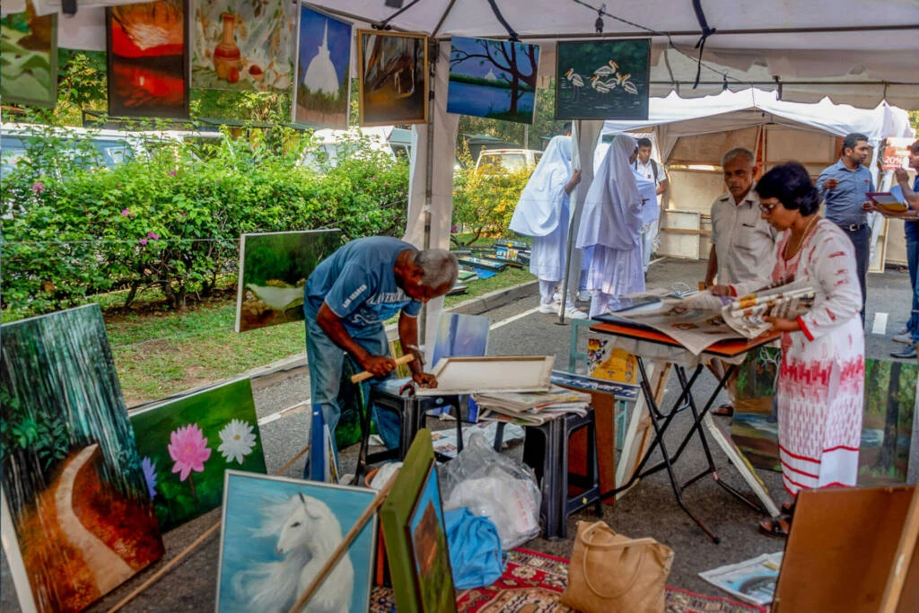A street scene featuring multiple tents set up along both sides, creating a vibrant and bustling atmosphere.