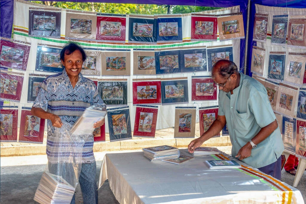 A man and woman collaboratively painting on a large canvas, showcasing their artistic creativity and teamwork.
