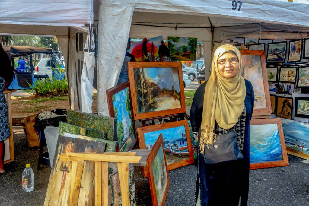A man interacting and sharing books with others around him.