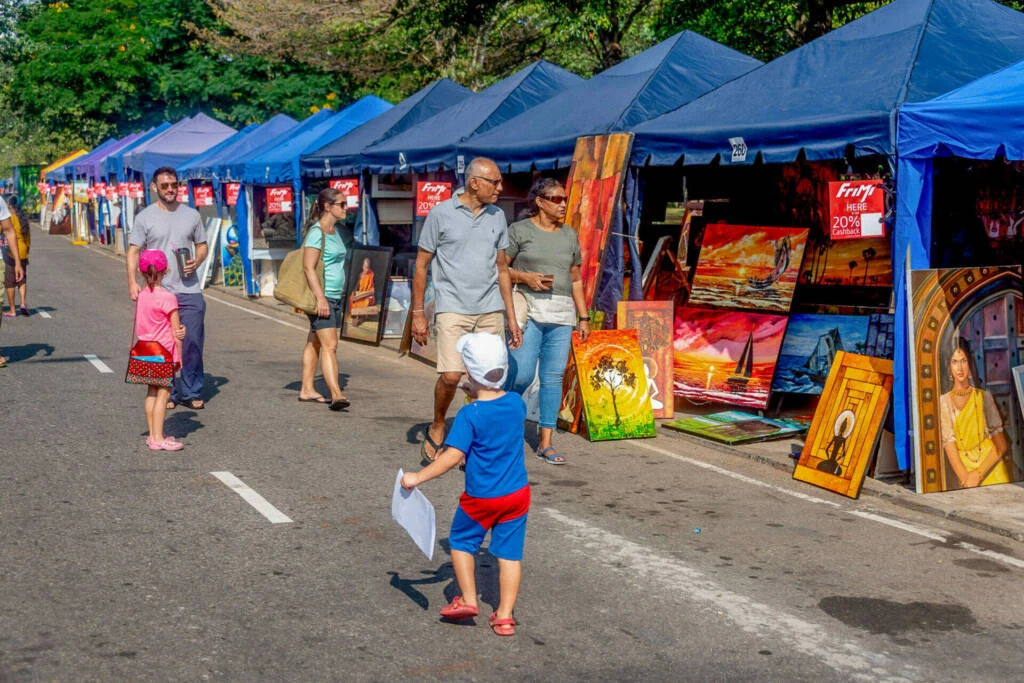 A woman engages in conversation with another woman at a table, sharing ideas and insights in a friendly setting.