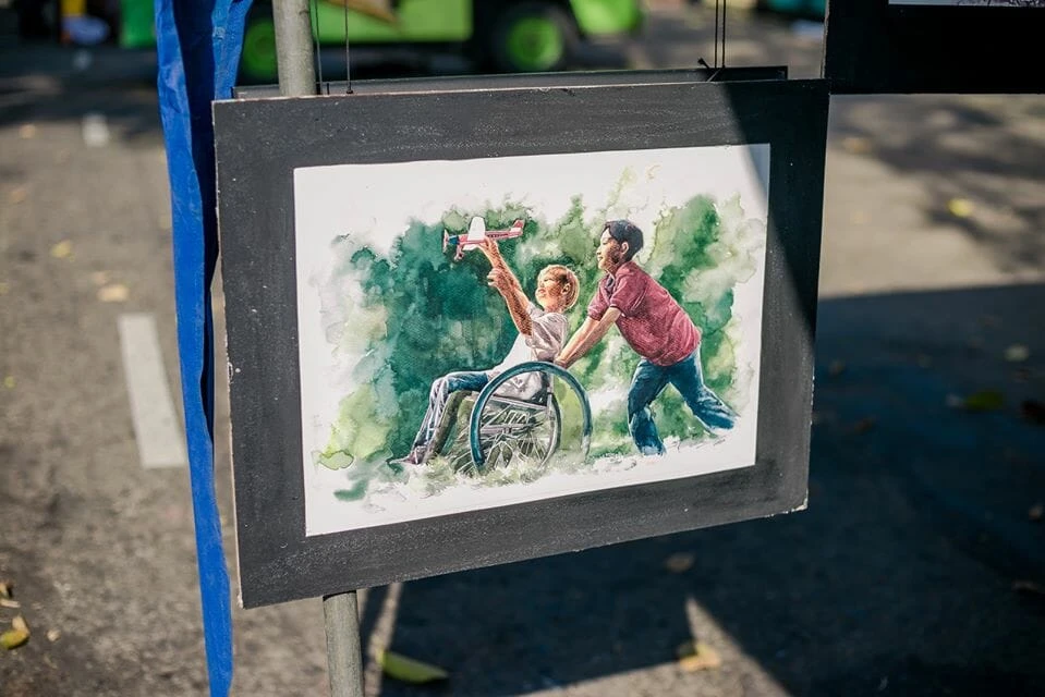 A group of people gathered around a large bull sculpture, engaging in conversation and admiring the artwork.