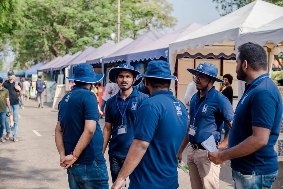 A couple enjoys a leisurely walk through an outdoor market, exploring various stalls filled with fresh produce and crafts.