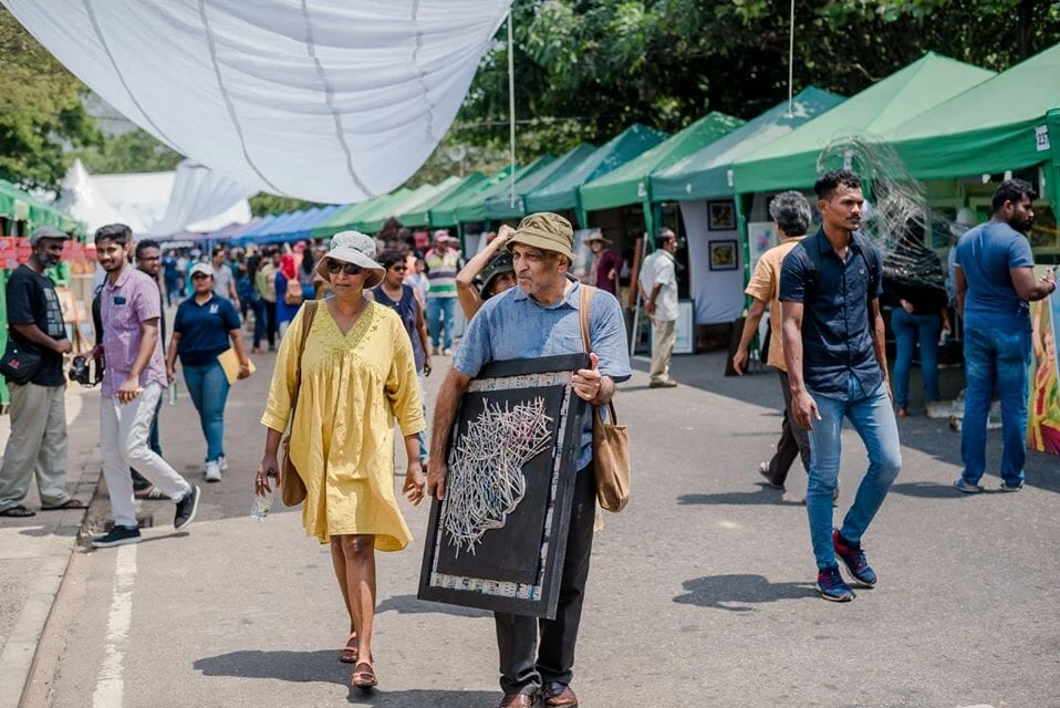 A group of women in traditional costumes performing energetically on stage, showcasing cultural heritage and artistry.