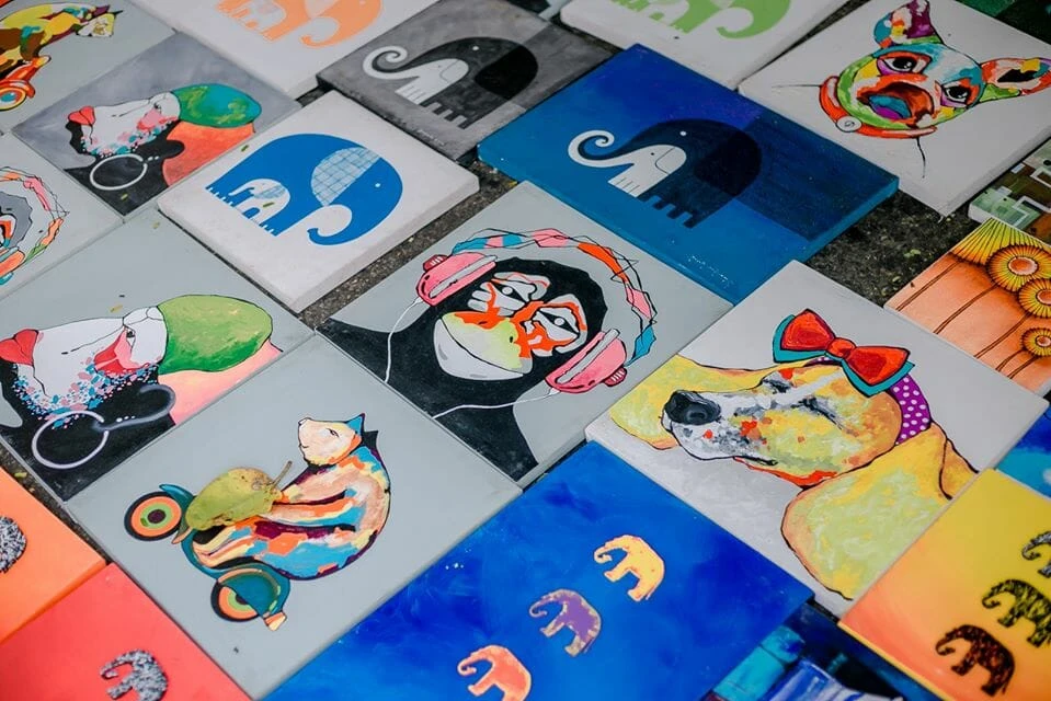 A vibrant collage of various colored pictures displayed on a large wall, showcasing diverse themes and styles.