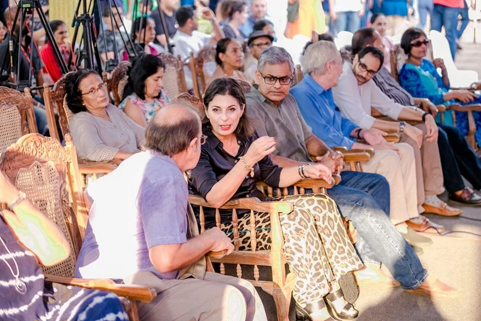 A group of women in traditional attire performing on stage, showcasing cultural dance and vibrant costumes.