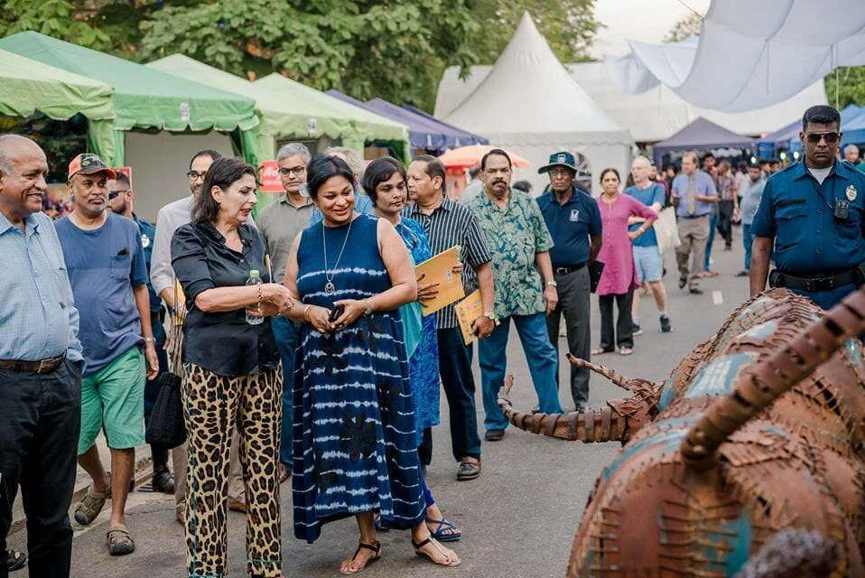 Women dressed in traditional clothing captivating the audience with a vibrant performance on stage.