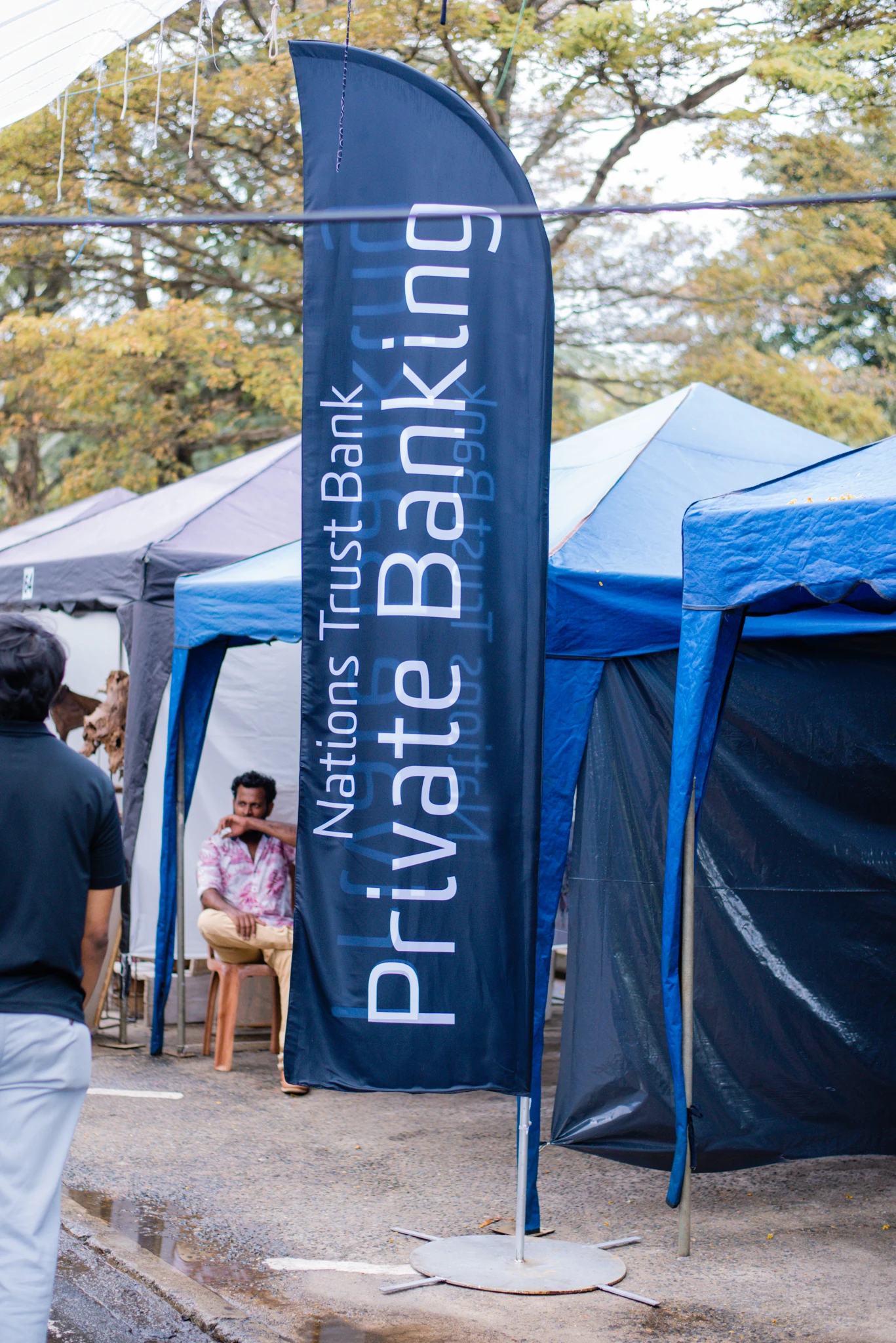A blue tent displaying a sign for Nation Trust Bank, representing private banking services.