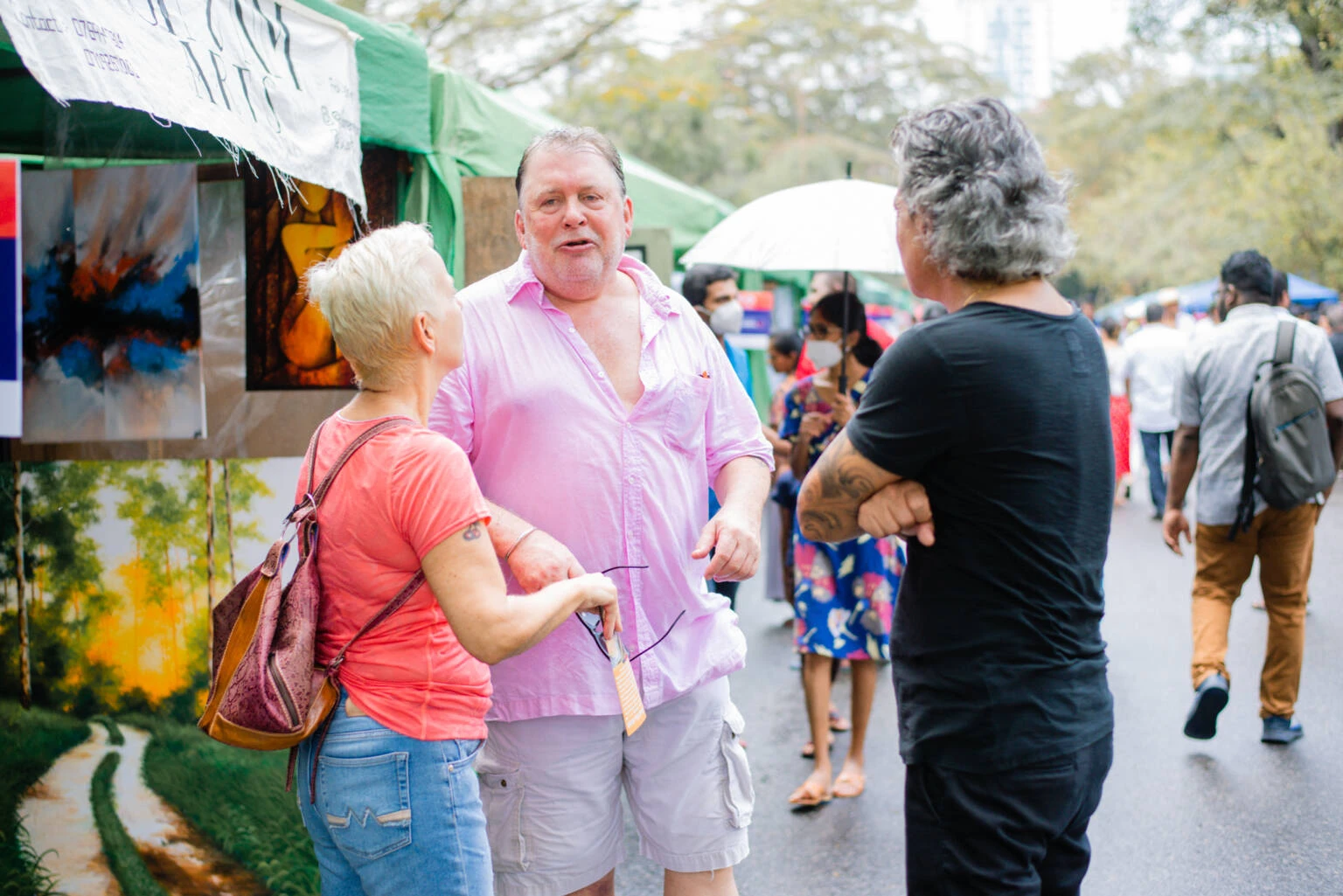 A man and woman are seen discussing with another man, creating an atmosphere of dialogue and interaction.