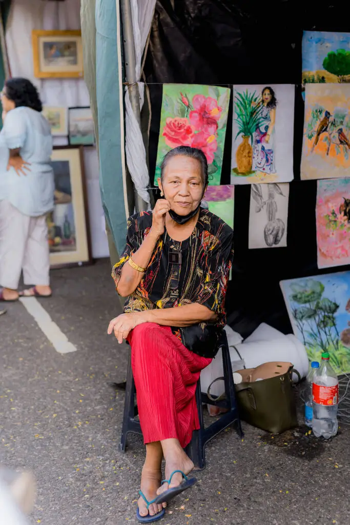 A woman seated comfortably on a chair, exuding a sense of relaxation and contemplation.
