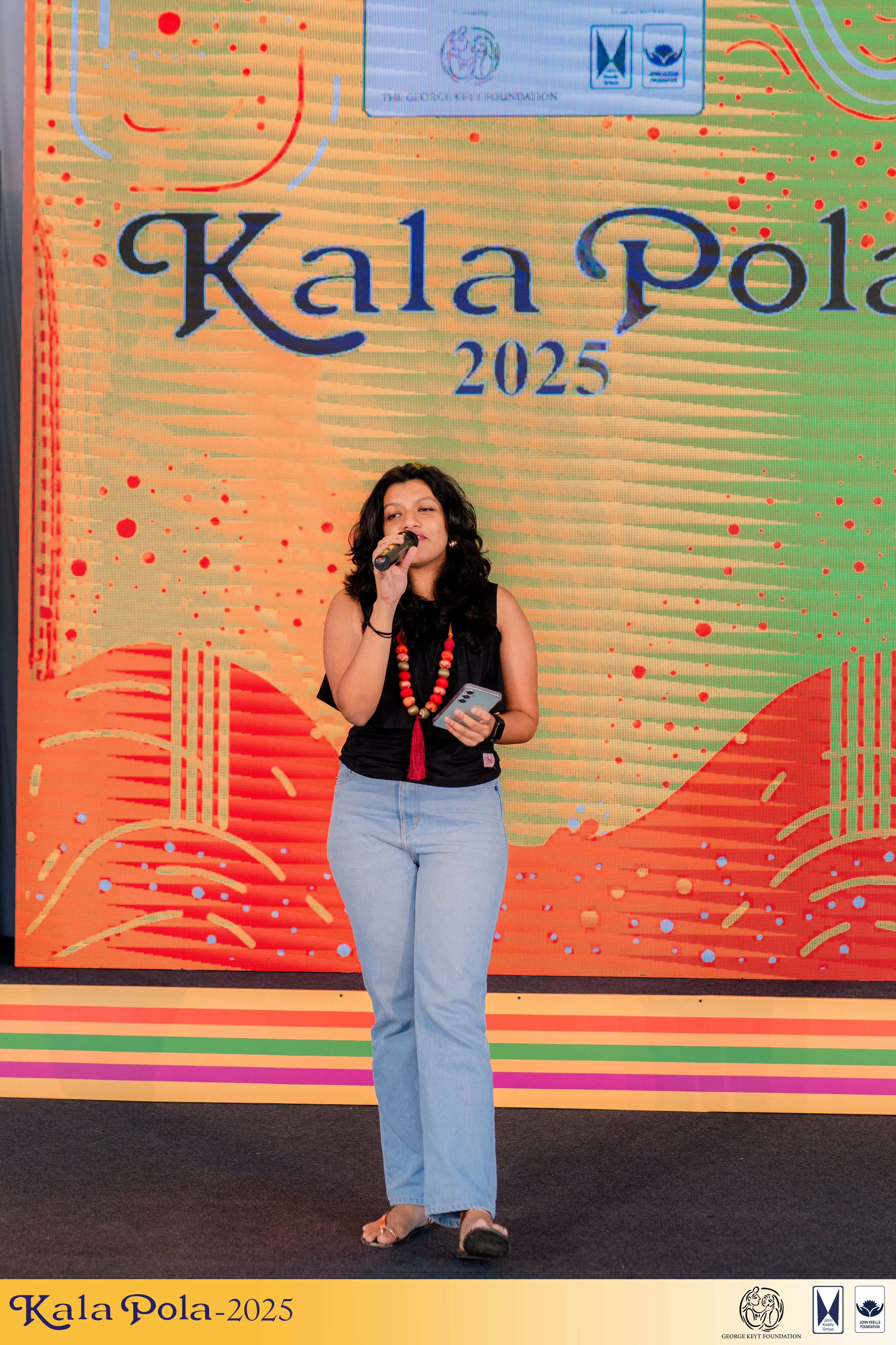 A lively ensemble of musicians on stage, showcasing their talent with drums in a dynamic performance.