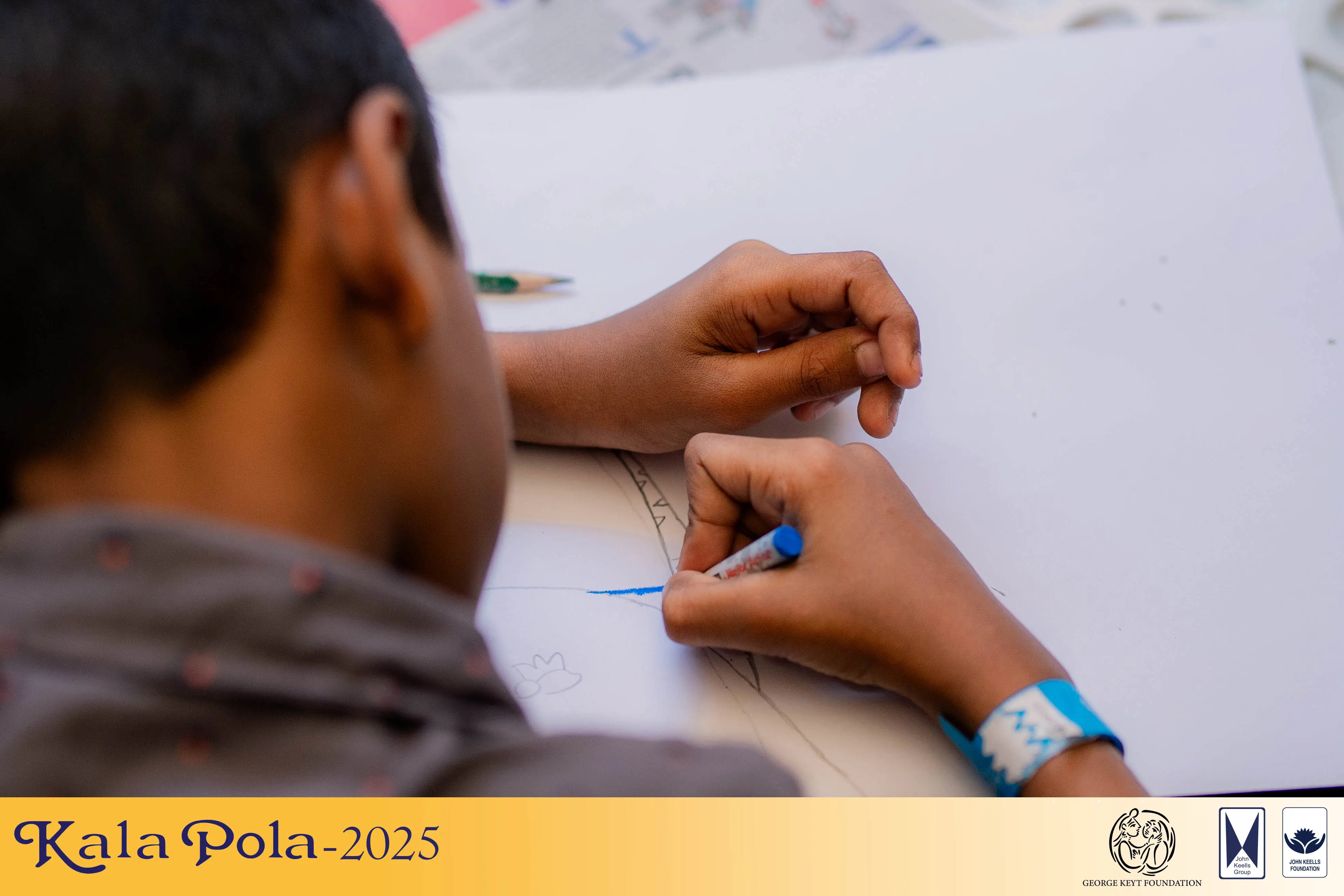 Individuals congregate near a wall featuring colorful graphic, representing urban expression and collective presence.