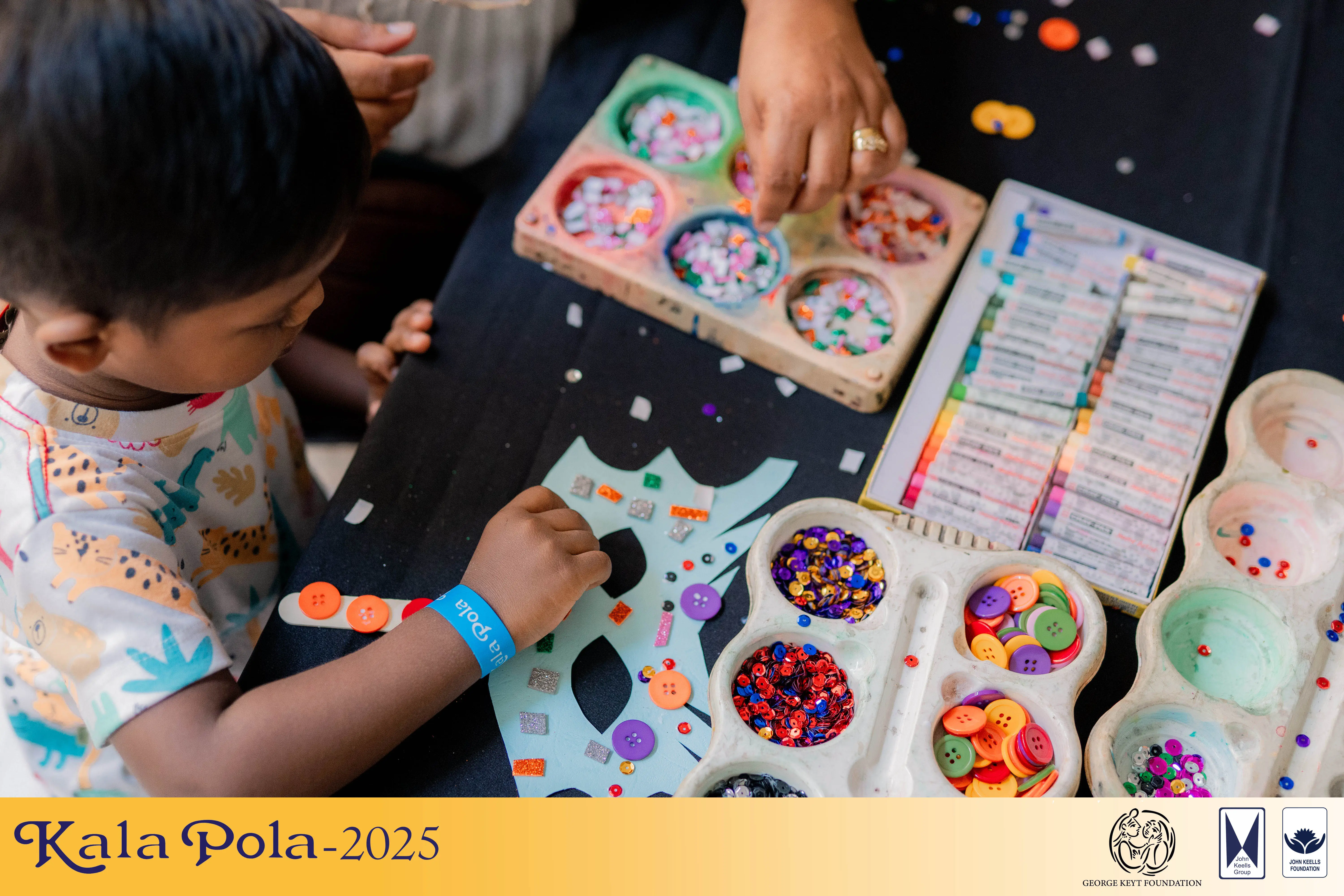 A man in a blue shirt poses, exuding a relaxed and stylish demeanor in a simple yet effective outfit.