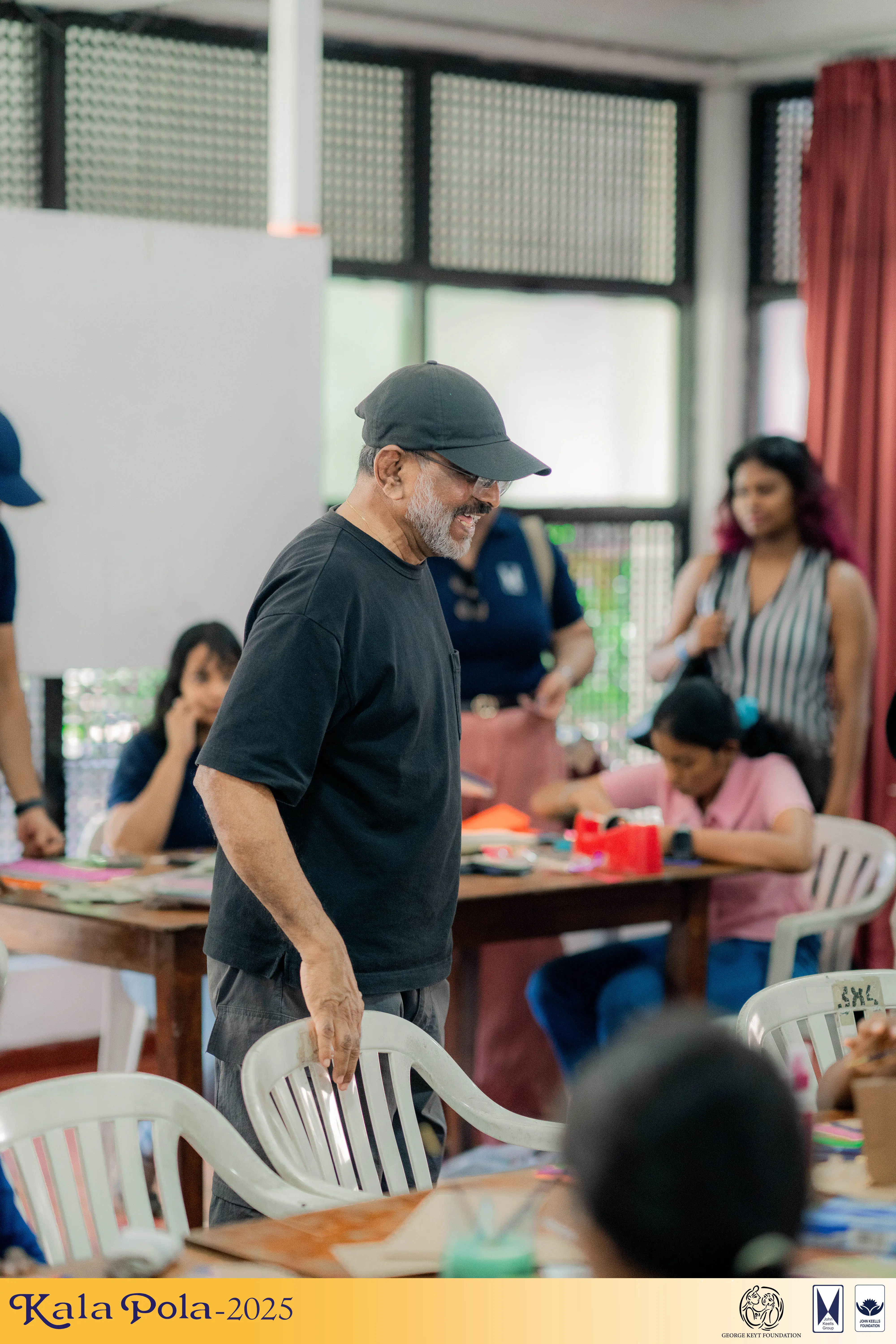 A diverse group of individuals seated in chairs, enjoying an outdoor event.