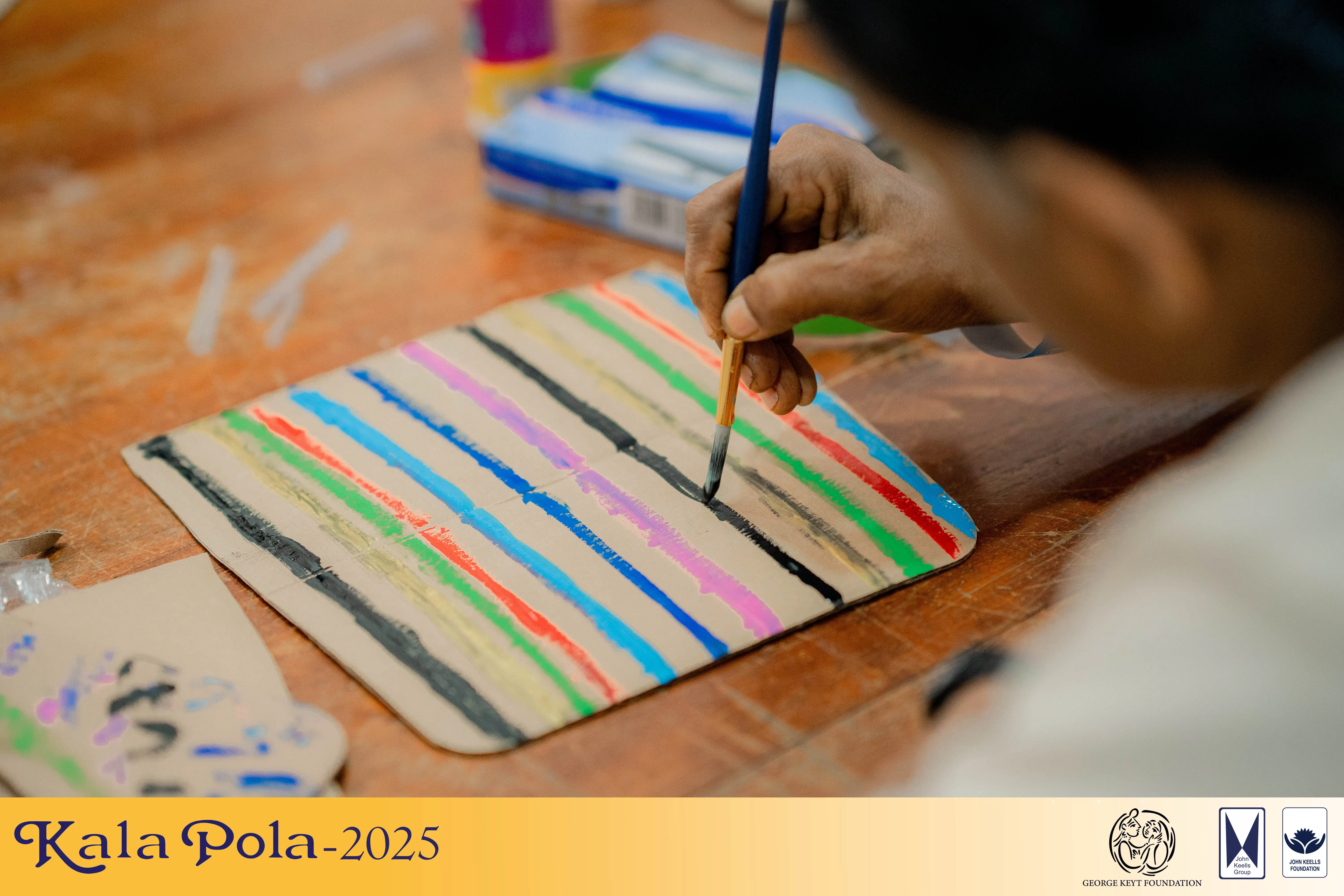 Two women engaged in painting together while seated at a table, showcasing creativity and collaboration.