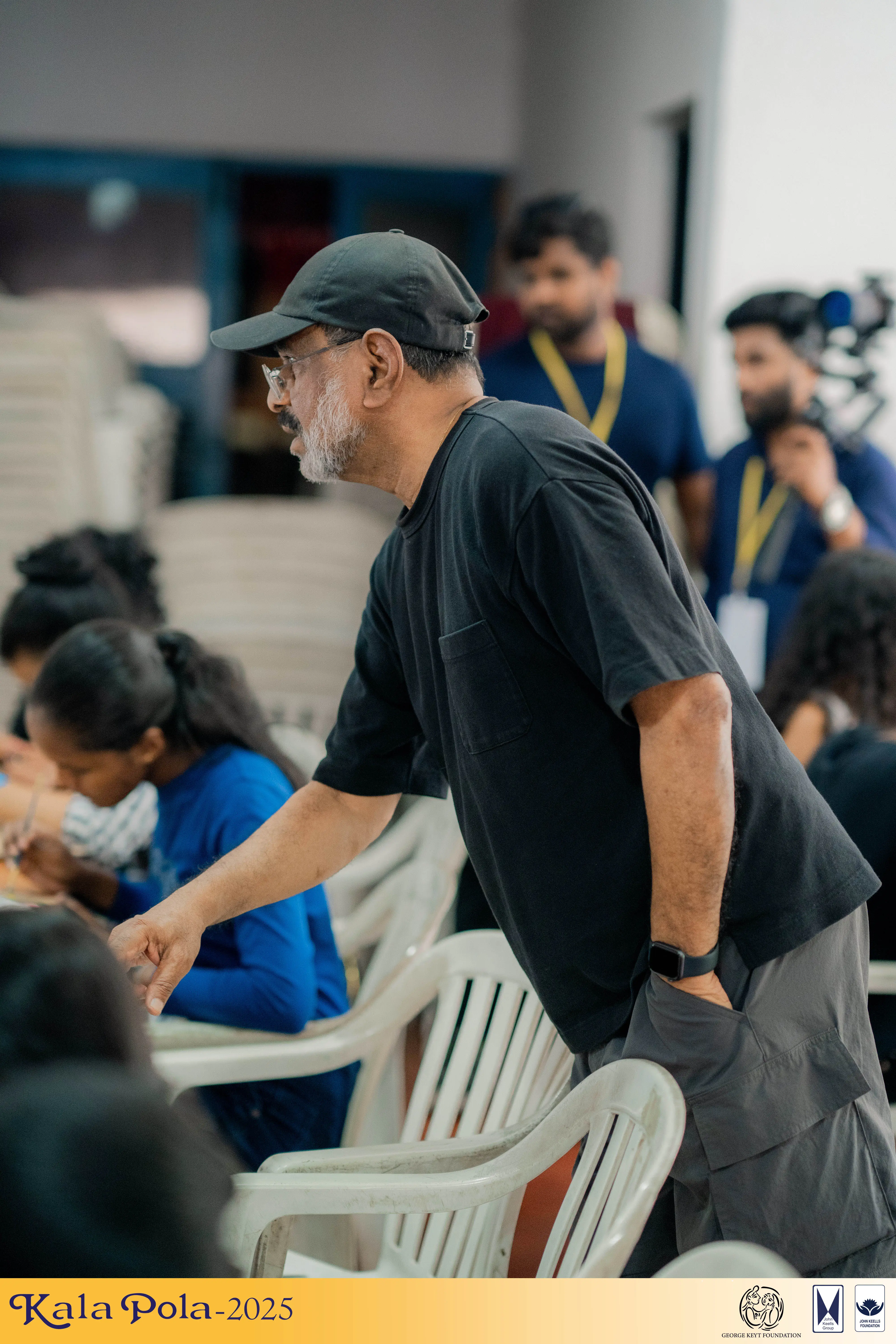 A diverse group of individuals seated in chairs, engaged in conversation and sharing ideas in a collaborative setting.