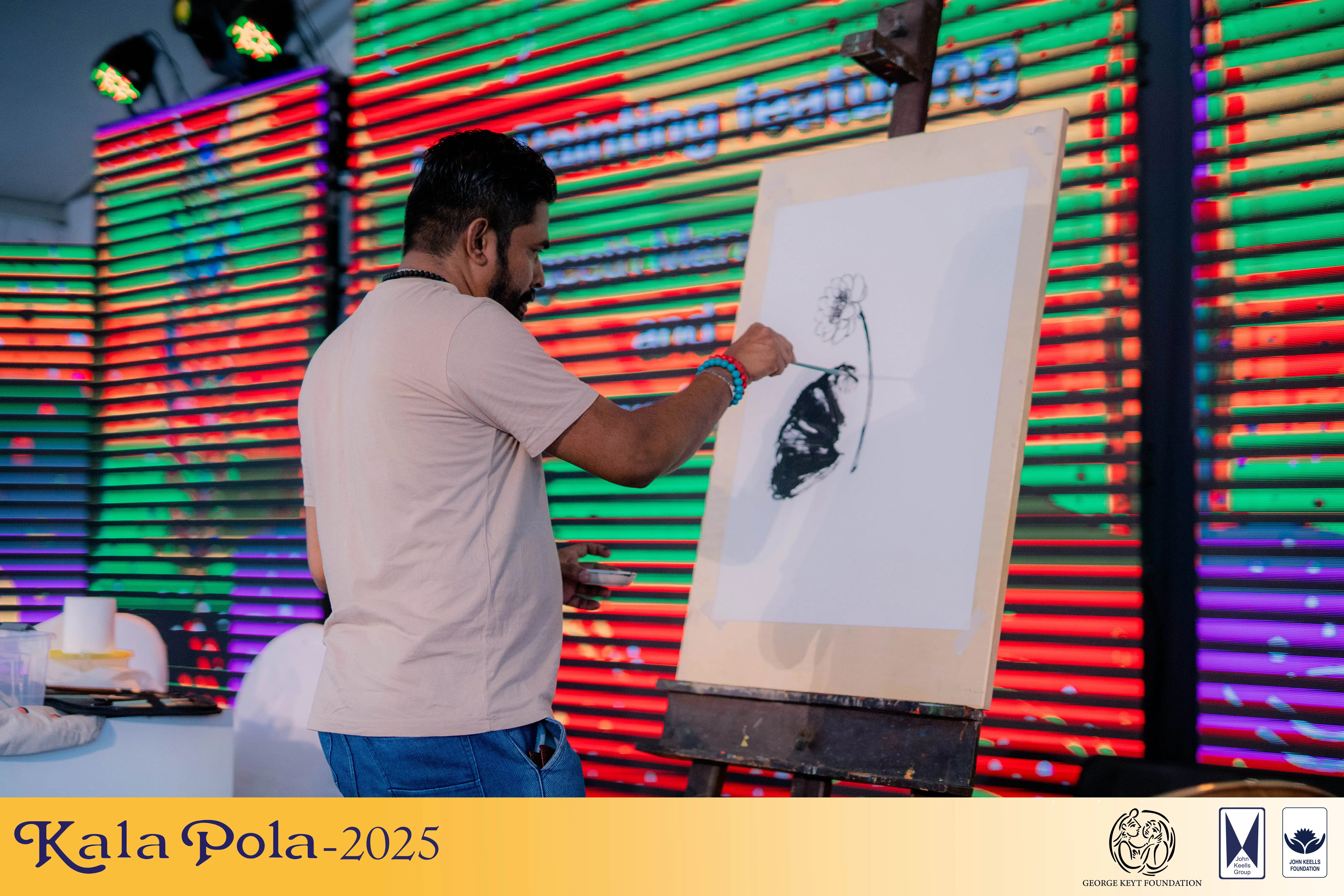 A diverse group of individuals gathered around a tent adorned with various colorful paintings.