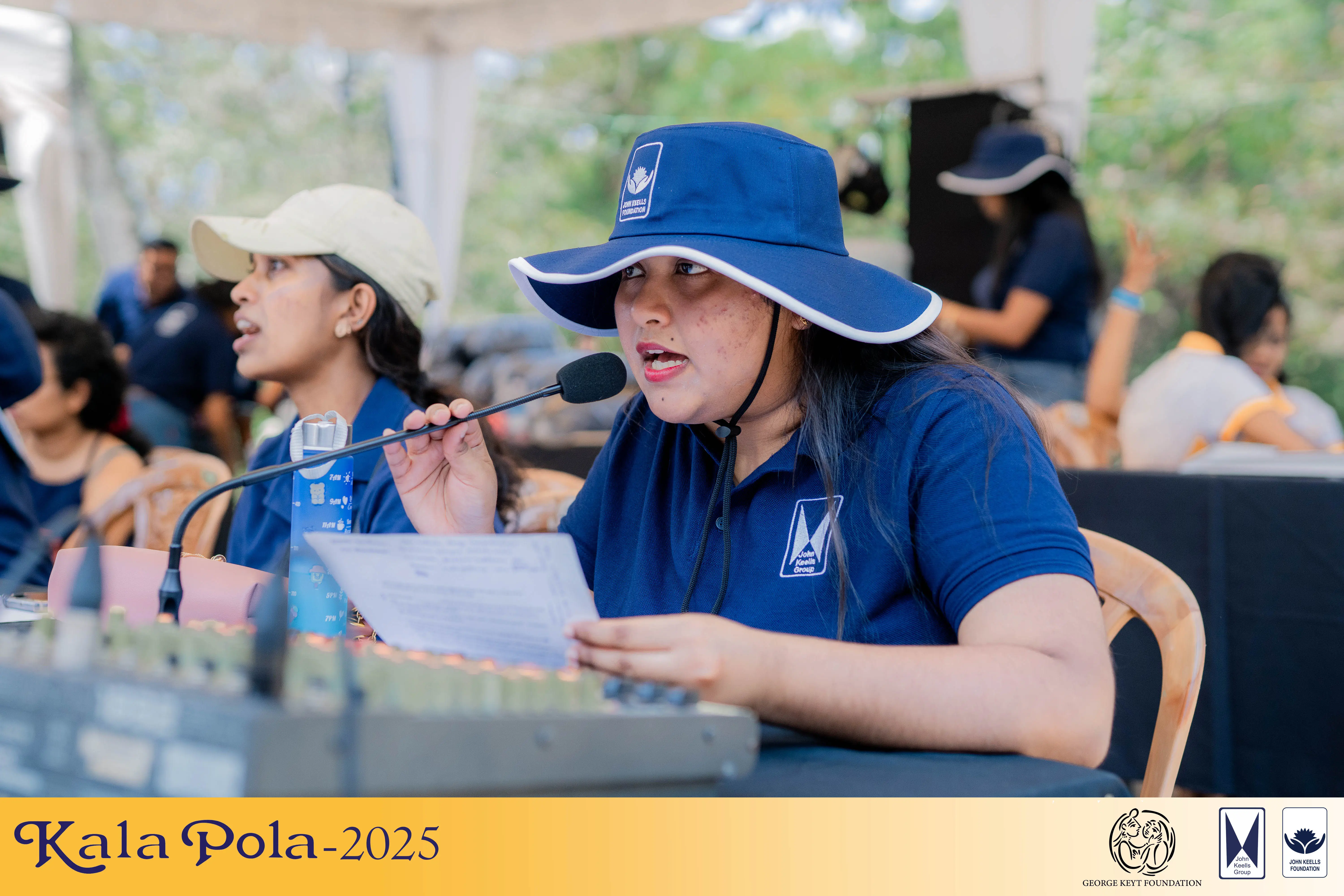 Two women and one man sitting on a bench outdoors, talking and singing together.